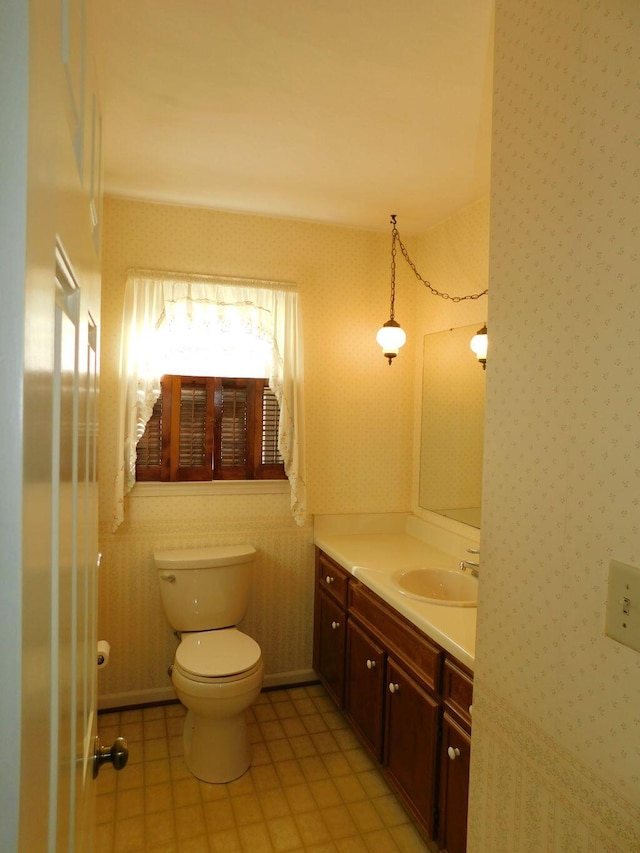 bathroom with tile patterned flooring, vanity, and toilet