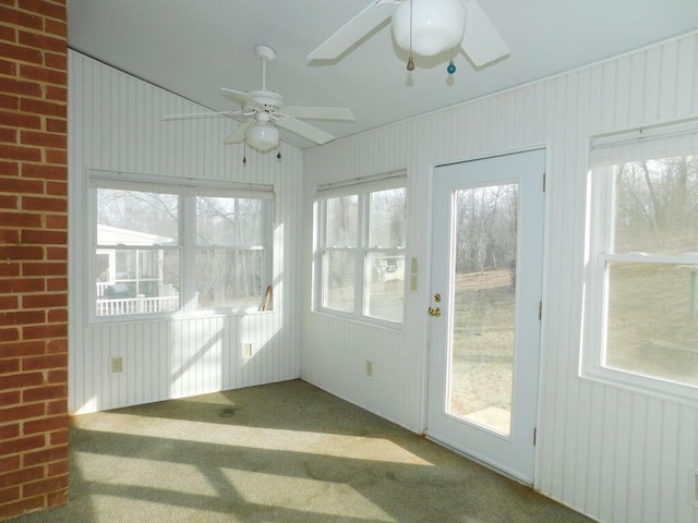 unfurnished sunroom featuring ceiling fan