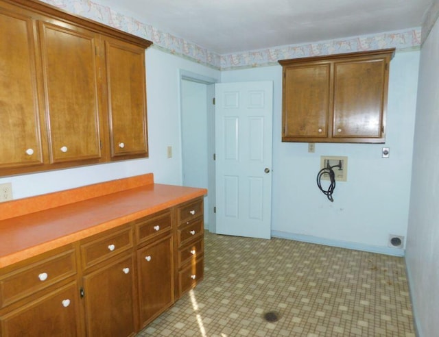 clothes washing area featuring cabinets, electric dryer hookup, and washer hookup