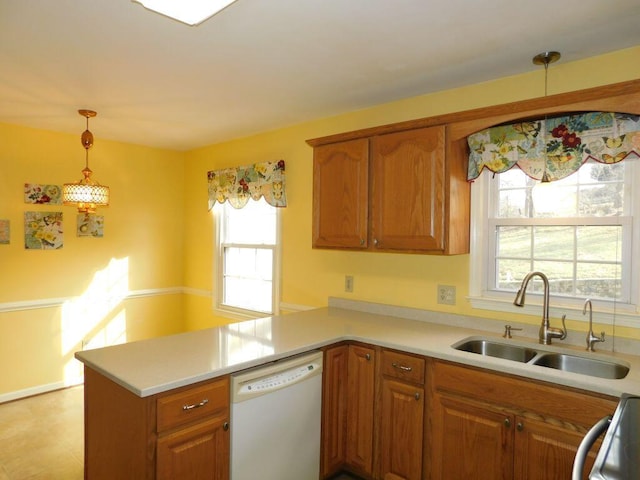 kitchen featuring pendant lighting, sink, kitchen peninsula, and dishwasher