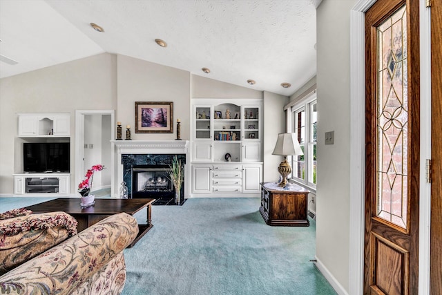 living area with lofted ceiling, a textured ceiling, a fireplace, and carpet flooring