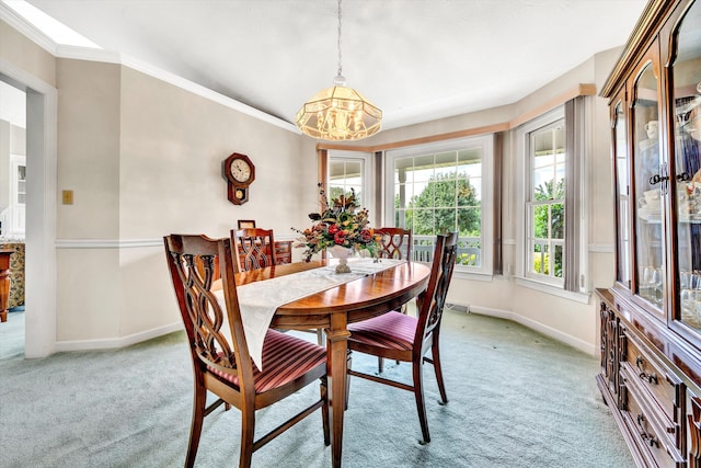 dining space with baseboards, ornamental molding, and light colored carpet