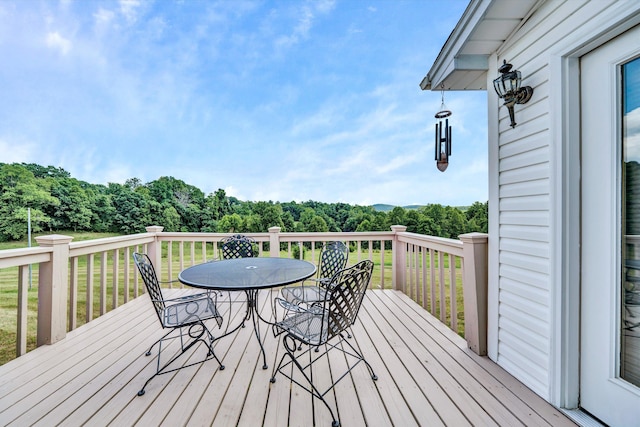 wooden terrace with outdoor dining area