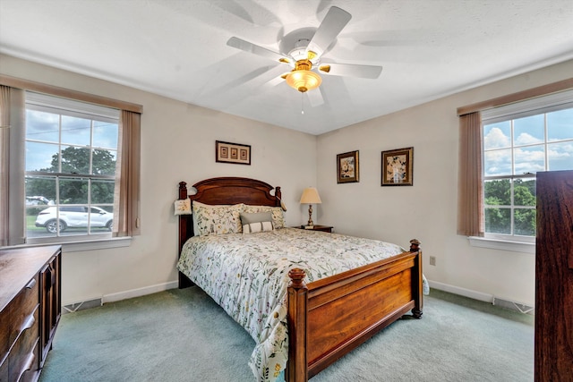 bedroom featuring light carpet, visible vents, and baseboards