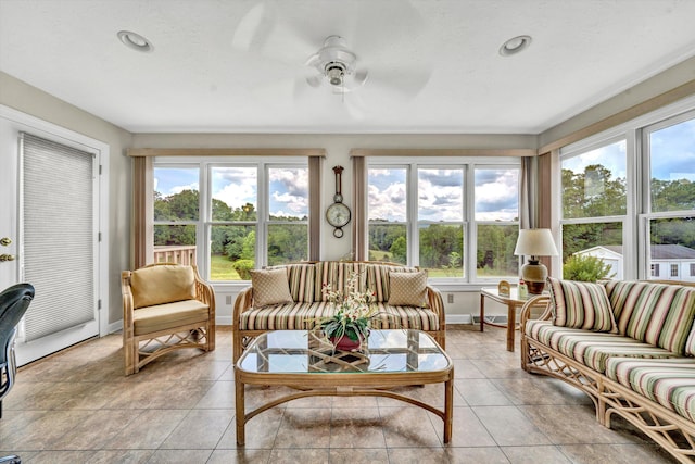 sunroom / solarium featuring a ceiling fan