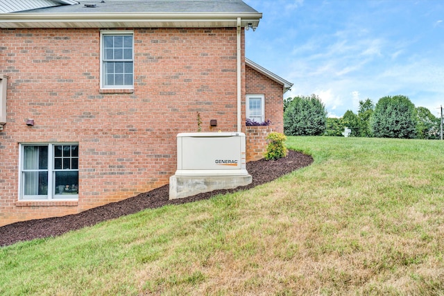 view of side of home with brick siding and a lawn