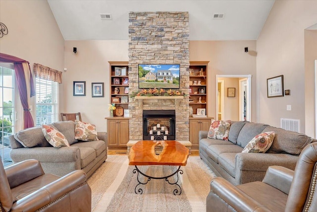 living room featuring a fireplace, high vaulted ceiling, and light hardwood / wood-style flooring