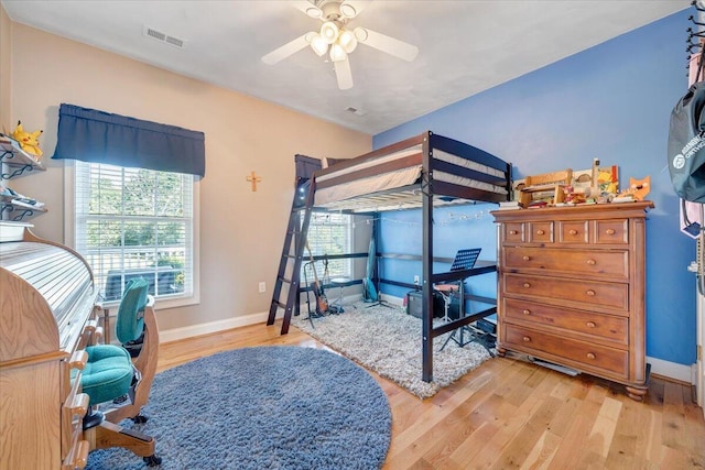 bedroom with light hardwood / wood-style floors and ceiling fan