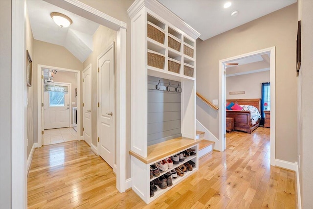 mudroom featuring wood-type flooring and lofted ceiling