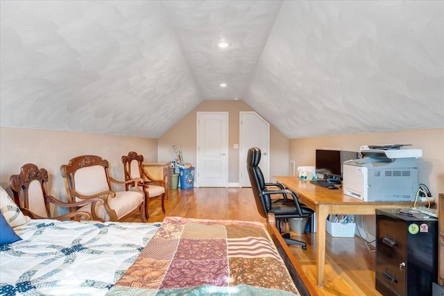 bedroom featuring vaulted ceiling and light hardwood / wood-style floors