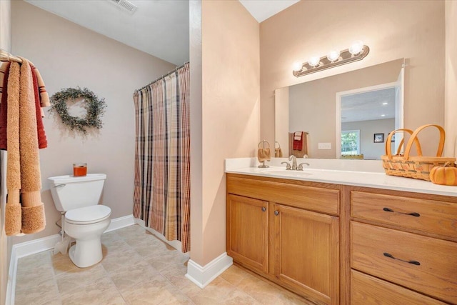 bathroom with vanity, tile patterned floors, toilet, and walk in shower