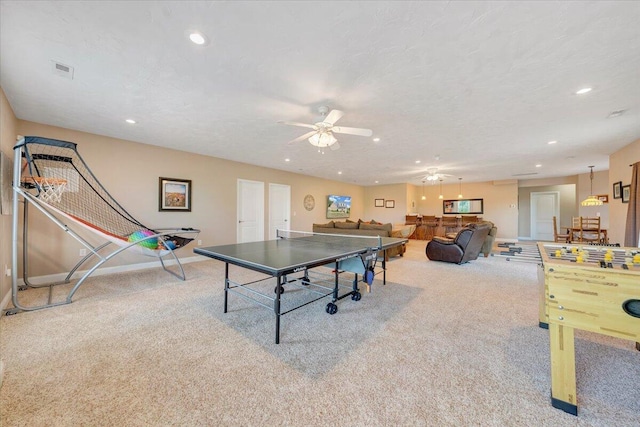 playroom featuring ceiling fan, light colored carpet, and a textured ceiling