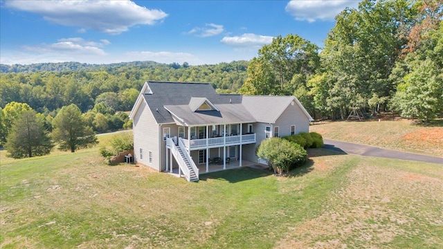 exterior space with a wooden deck and a front yard