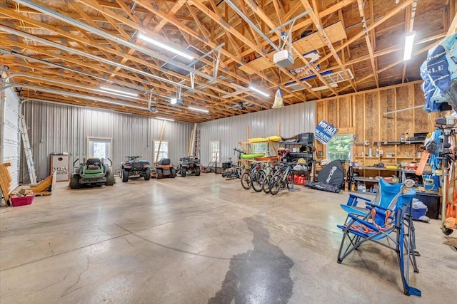 garage with a garage door opener and a workshop area