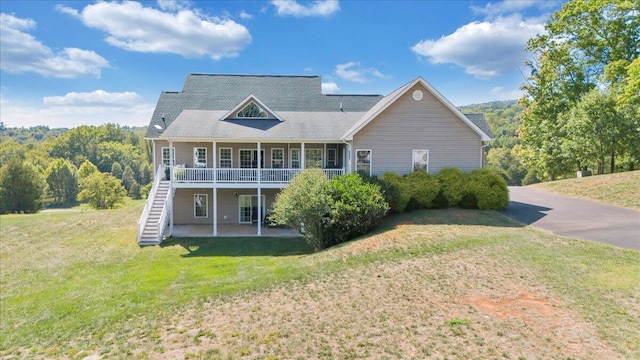 back of property featuring a lawn and a patio