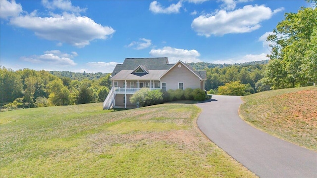 view of front of home with a front yard and covered porch