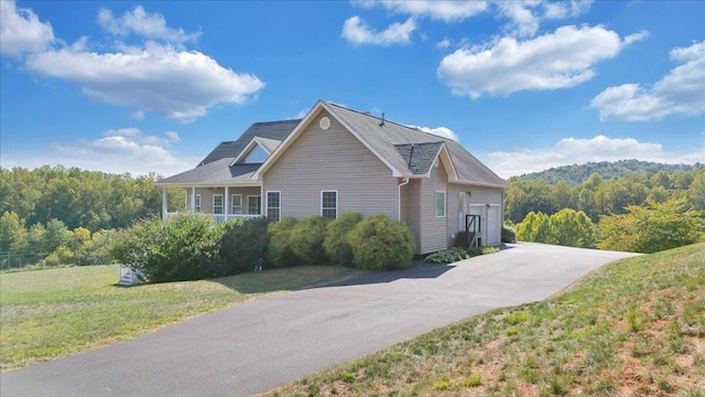 view of property exterior with a garage and a lawn