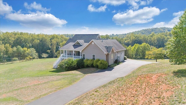 view of front of property with covered porch and a front yard