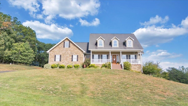 cape cod-style house with a front yard and covered porch