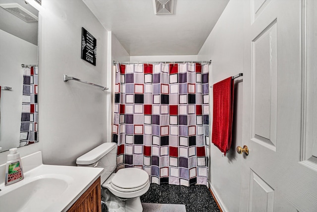 bathroom with vanity, curtained shower, and toilet