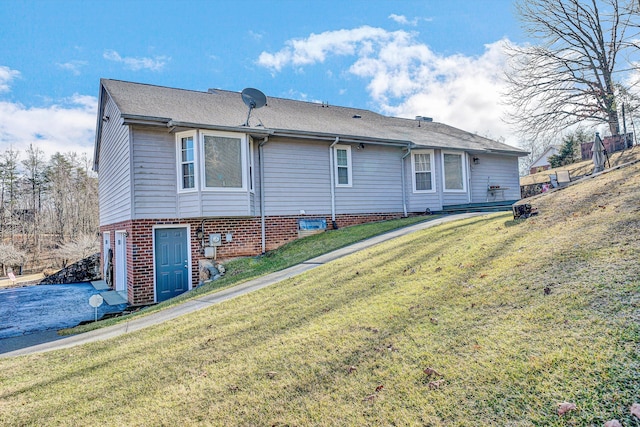 rear view of house featuring a yard