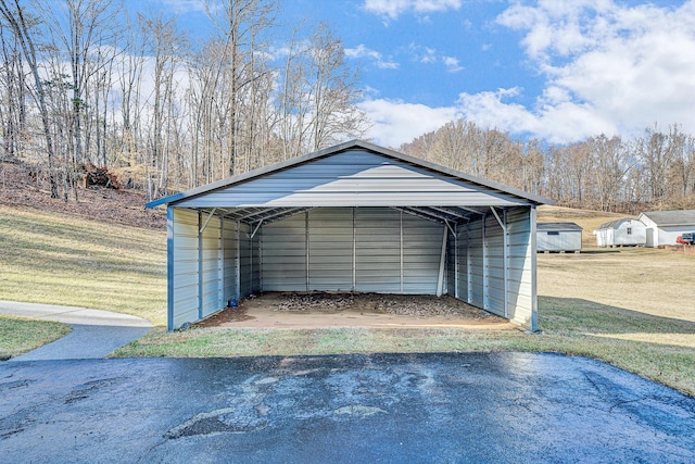 garage with a carport and a yard