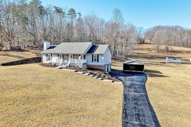 view of front of home with a porch and a front yard