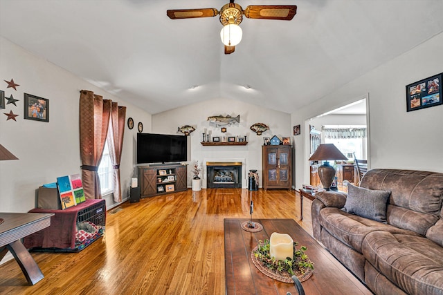 living room featuring ceiling fan, lofted ceiling, and hardwood / wood-style floors