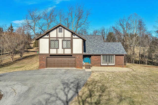 back of house featuring a yard and a garage