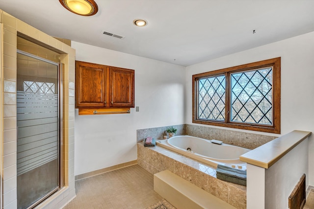 bathroom with tile patterned floors and separate shower and tub