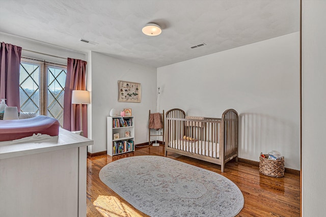 bedroom with hardwood / wood-style floors