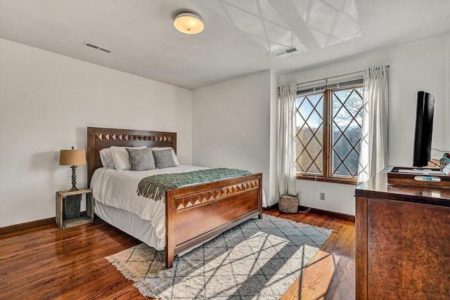 bedroom with dark wood-type flooring