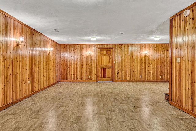 spare room featuring ornamental molding and hardwood / wood-style floors