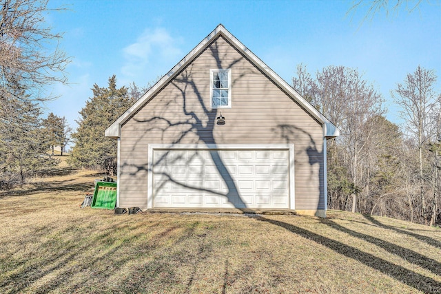 garage featuring a lawn