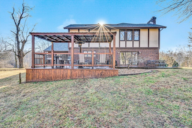 back of house featuring a wooden deck and a lawn