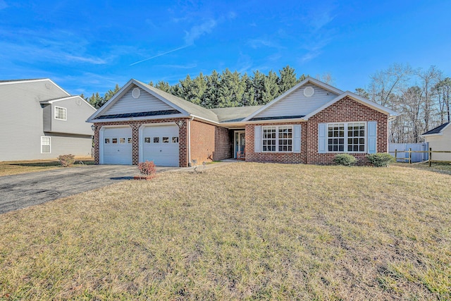 ranch-style house featuring a garage and a front yard