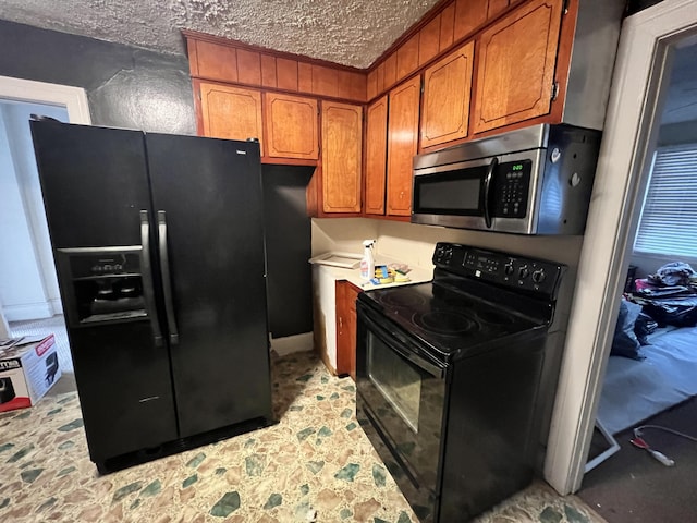 kitchen with black appliances and a textured ceiling