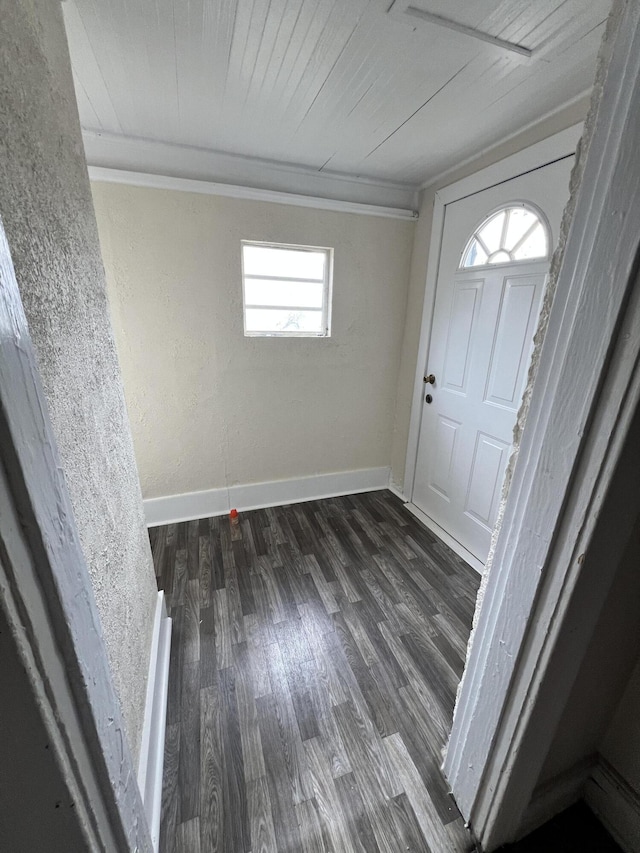 foyer entrance featuring dark hardwood / wood-style flooring, wood ceiling, and crown molding