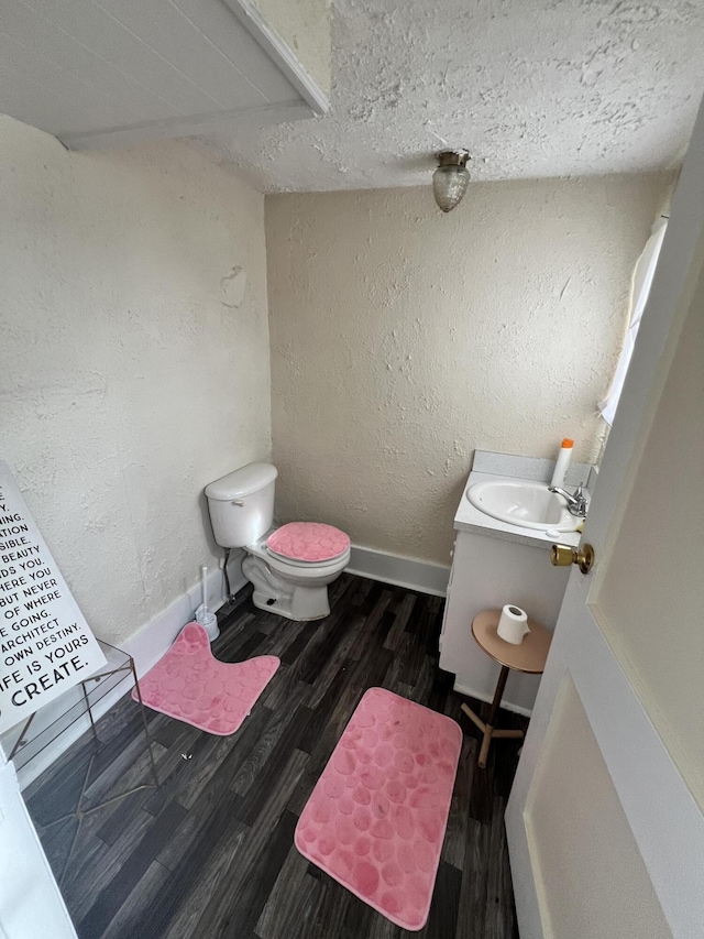 bathroom featuring vanity, hardwood / wood-style floors, and toilet