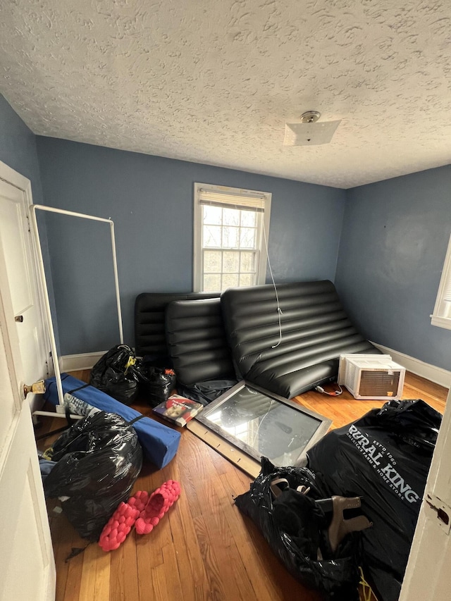 bedroom featuring hardwood / wood-style floors and a textured ceiling