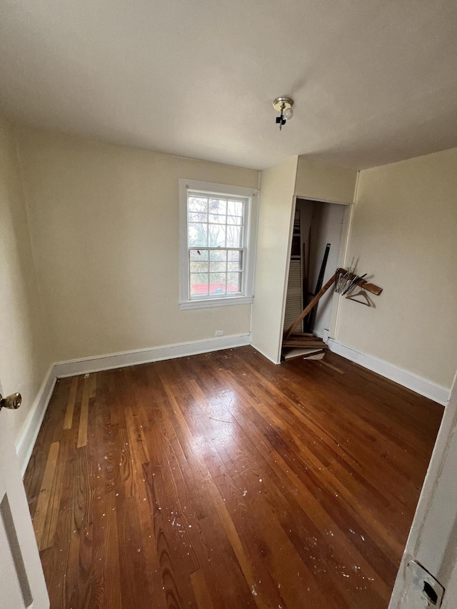 unfurnished room featuring dark hardwood / wood-style floors