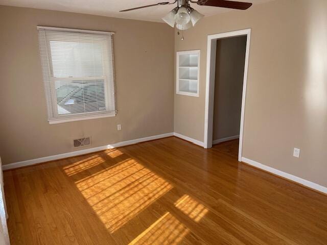 spare room with wood-type flooring and ceiling fan