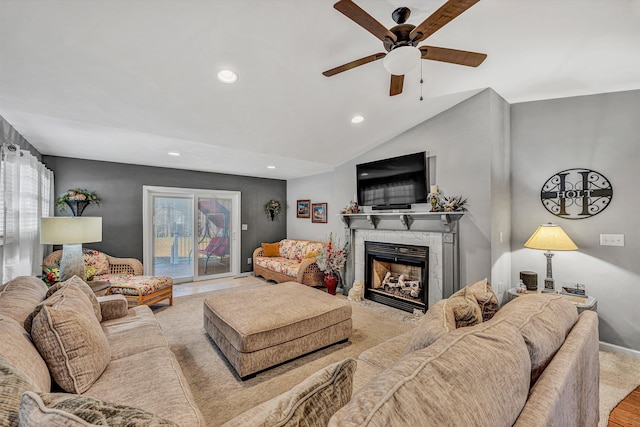 living room with vaulted ceiling, ceiling fan, and a fireplace