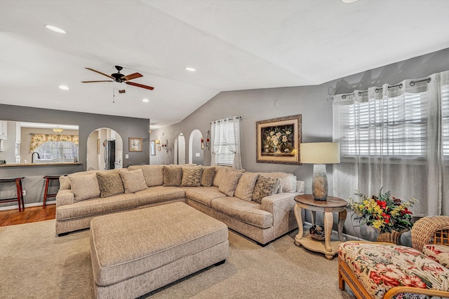 living room with vaulted ceiling, ceiling fan, and plenty of natural light