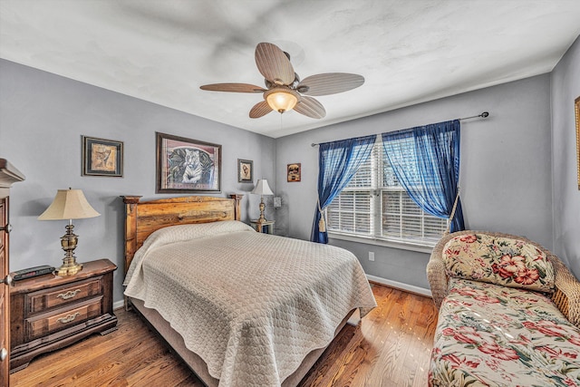 bedroom with wood-type flooring and ceiling fan