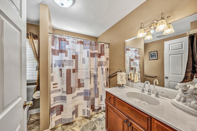 bathroom featuring vanity, toilet, and walk in shower