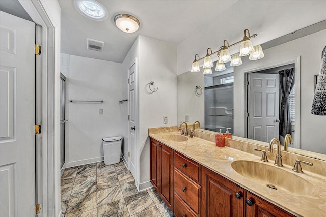 bathroom featuring vanity and a shower with door