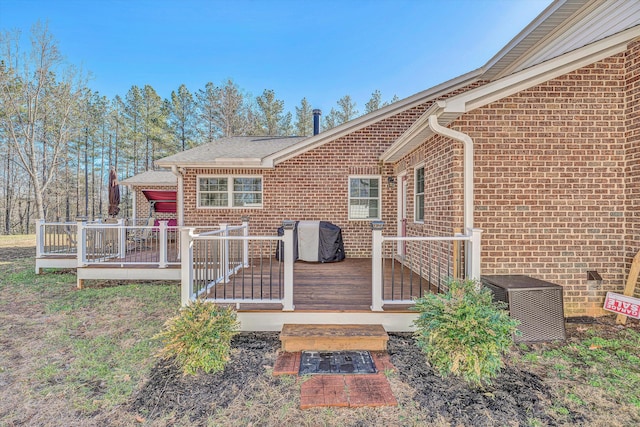 view of exterior entry with a deck