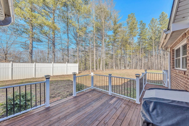 wooden terrace with a grill and a yard