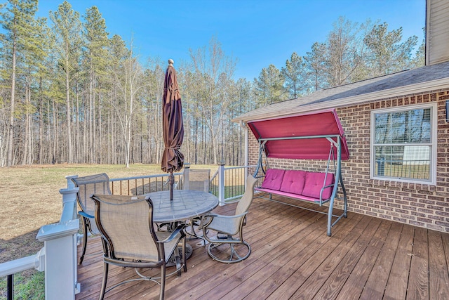 wooden terrace featuring a yard